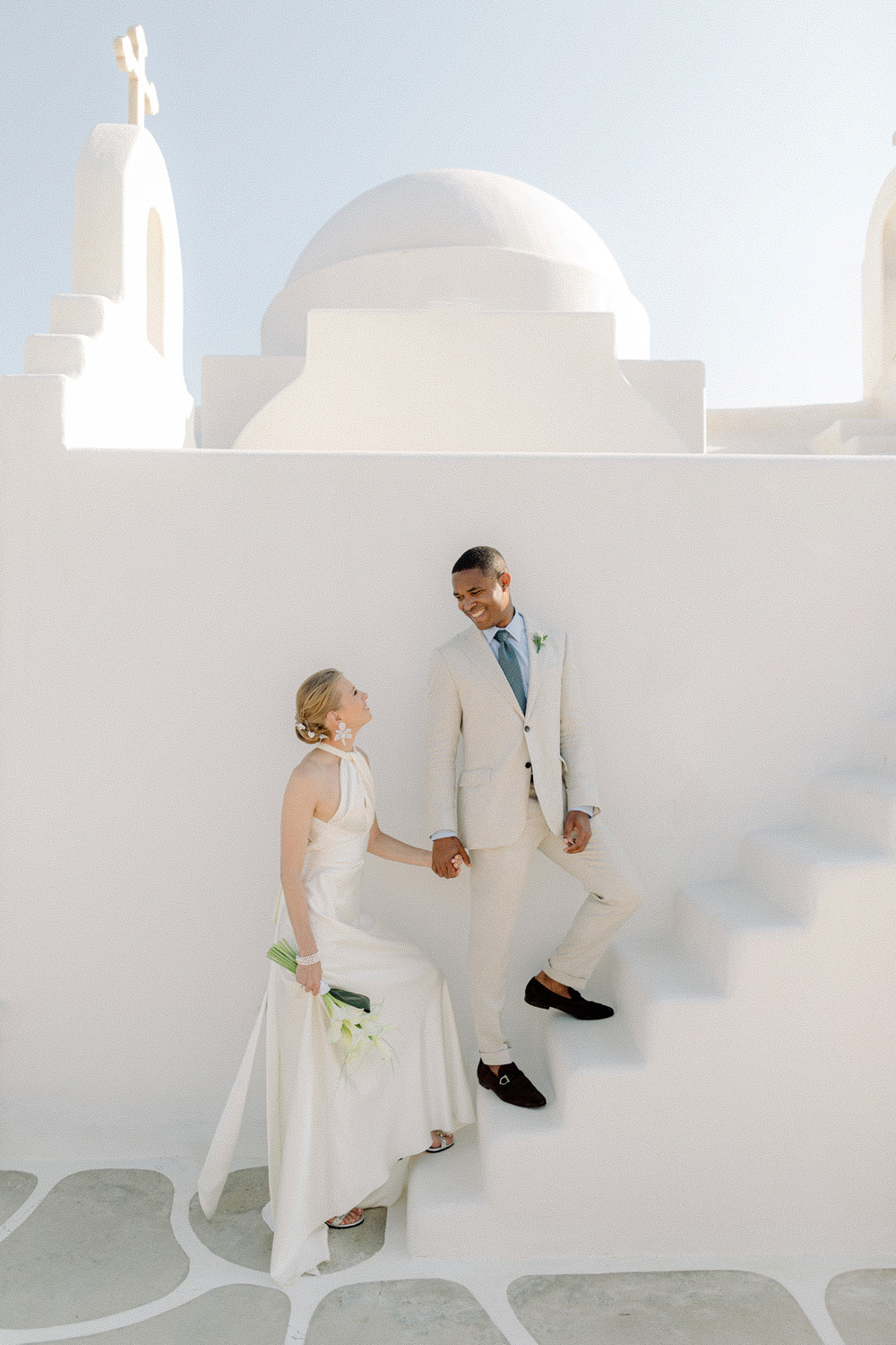 Greece wedding photographer captures couple near white washed chapel
