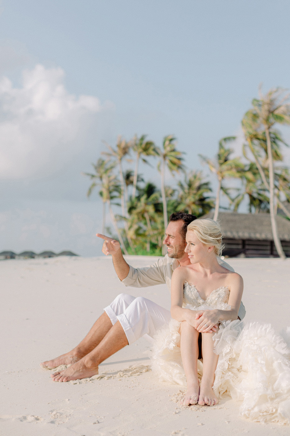 maldives wedding photographer captures couple enjoying the beach after their wedding ceremony
